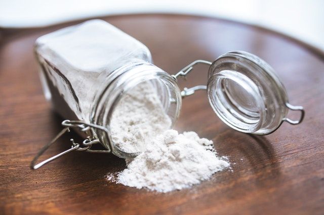 Jar of flour spilled on counter.