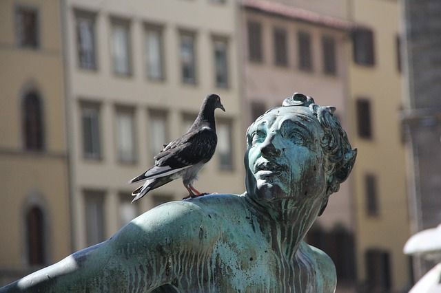 Statue with a bird on it.